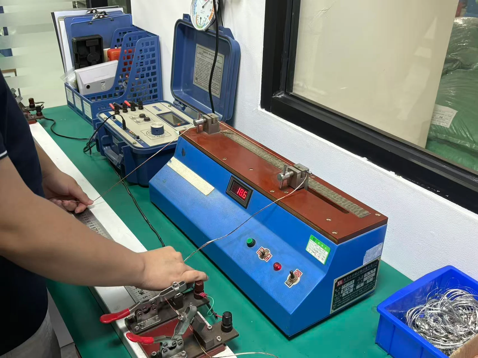 Conductor held in a resistance measurement fixture at ANYANG