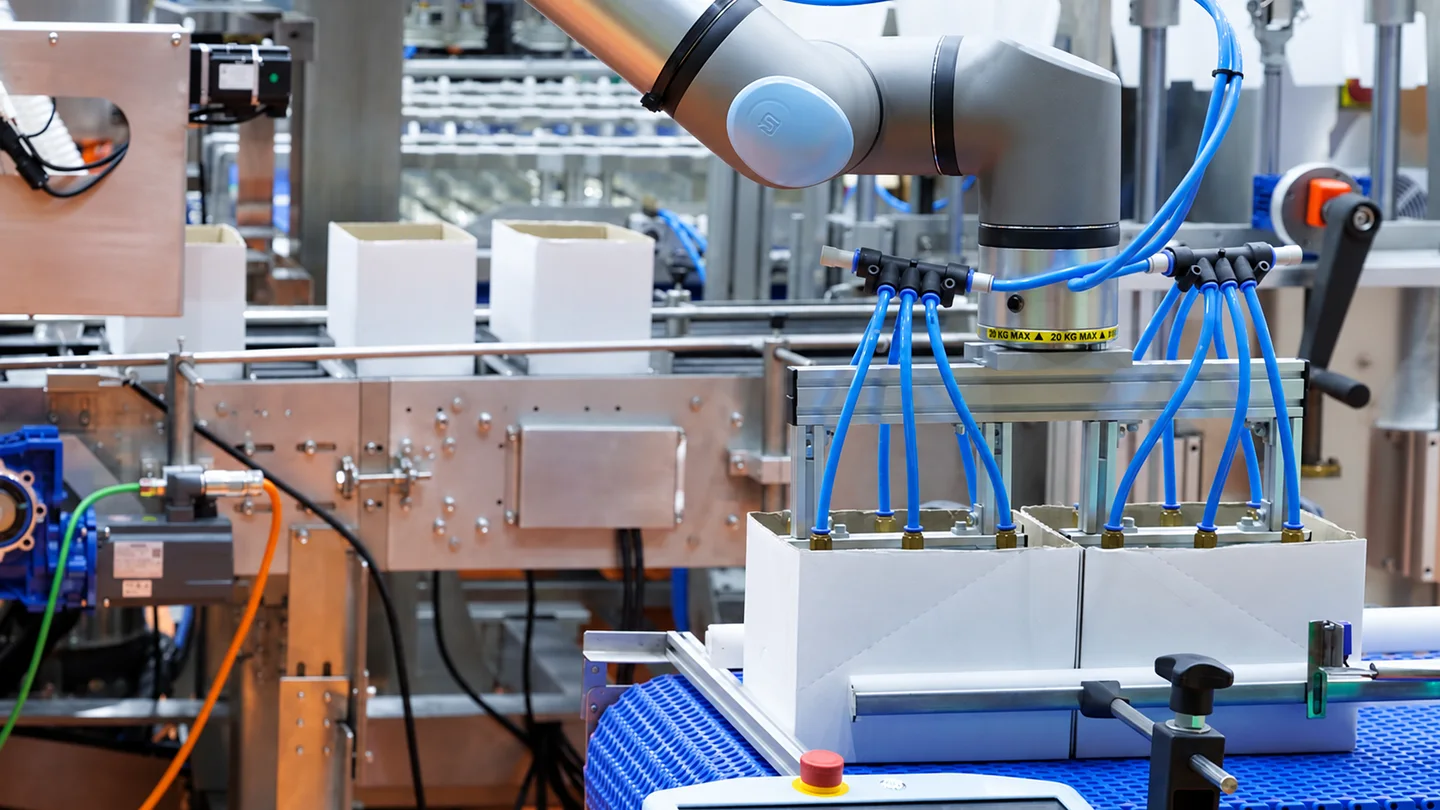 Industrial robot handling components at a conveyor