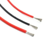 Material-library photograph of a black wire marked 12 AWG beside red silicone wire samples, showing insulation and stripped ends.