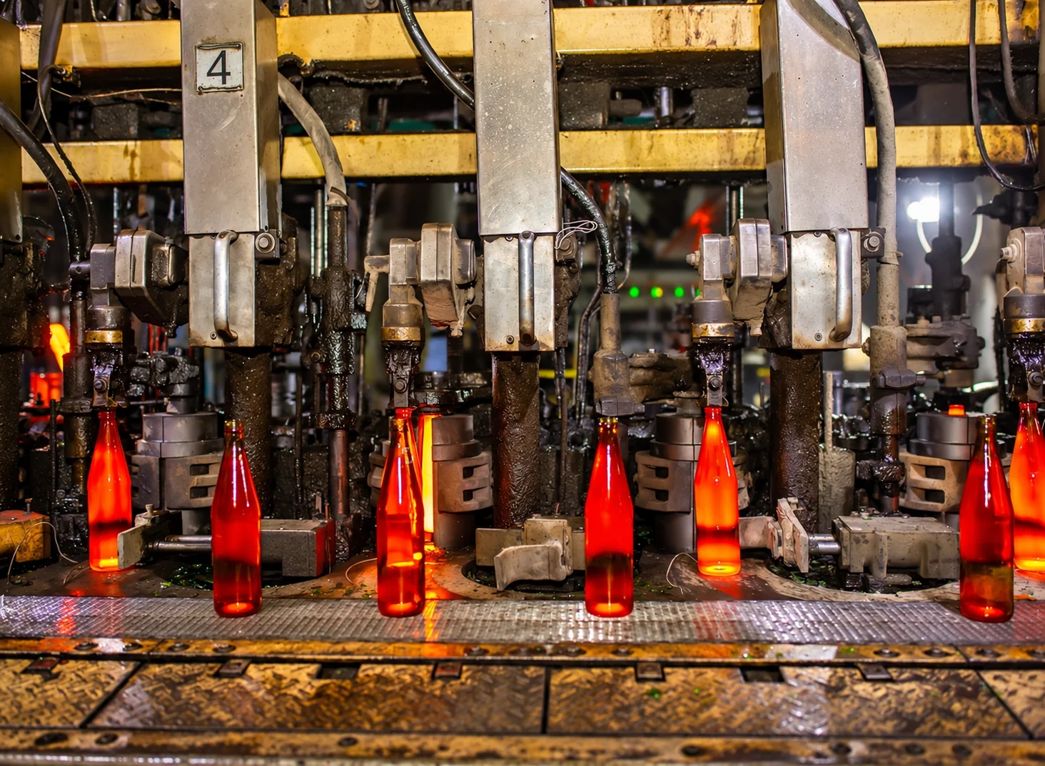 Hot glass bottles on a glass forming line
