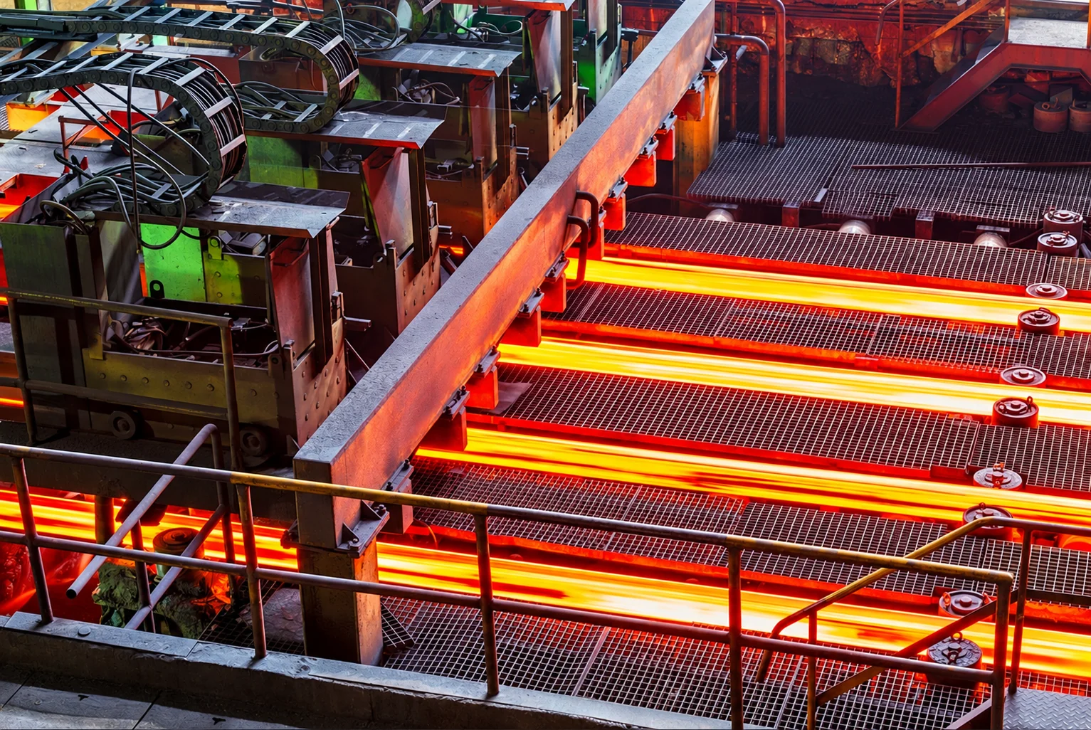 Hot steel billets moving through a steel processing line
