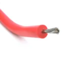 Thick red silicone insulation surrounding an exposed stranded conductor.