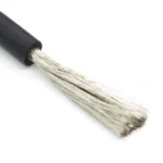 Close-up of fine metal strands emerging from a black silicone wire.