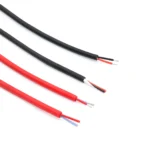 Material-library photograph of red and black two-core cable samples with outer sheath removed to show the insulated cores.
