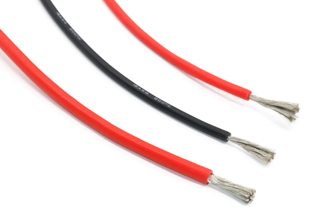 Three red and black silicone wire samples showing their stripped ends.