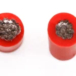 Two red silicone wire cut samples photographed from above.